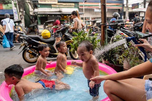 Trẻ em chơi đùa trong bể bơi bơm hơi giữa tiết trời nóng bức ở thủ đô Manila - Philippines vào cuối tháng 4.